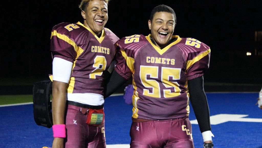 The founder and his brother smiling together in their football uniforms